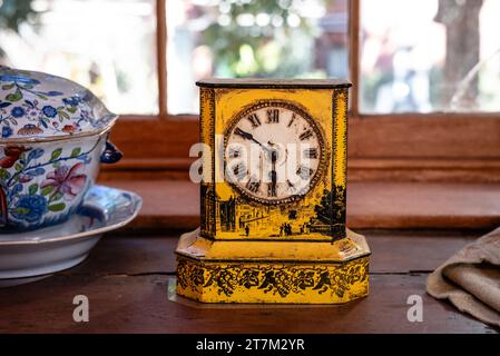 Clock and dishes in the Buttler's pantry of the Owens-Thomas House in Savannah, Georgia. Stock Photo