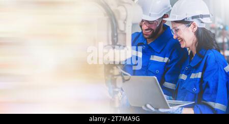 Two engineers mechanic using computer controller Robotic arm for welding steel in steel factory workshop. Industry robot programming software for auto Stock Photo