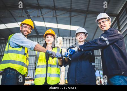 Engineers team mechanic standing in steel factory workshop. Industry robot programming software for automated manufacturing technology Stock Photo