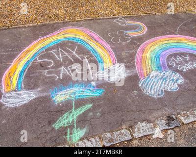 A colorful stay safe chalk drawing on pavement made by children at the time of lockdown Stock Photo