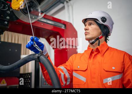 Engineers mechanic using computer controller Robotic arm for welding steel in steel factory workshop. Industry robot programming software for automate Stock Photo