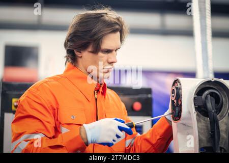 Maintenance engineering repair automatic welding robotic arm machine at production line in the industry factory. Stock Photo