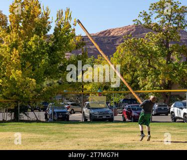 A competitor in a kilt tosses the caber in the Highland games at the Moab Celtic Festival, Scots on the Rocks, in Moab, Utah. Stock Photo