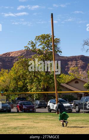 A competitor in a kilt tosses the caber in the Highland games at the Moab Celtic Festival, Scots on the Rocks, in Moab, Utah. Stock Photo