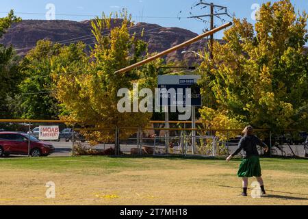 A competitor in a kilt tosses the caber in the Highland games at the Moab Celtic Festival, Scots on the Rocks, in Moab, Utah. Stock Photo