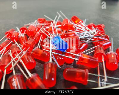 A row of Through Hole led diodes, red and blue color, electronic component Stock Photo