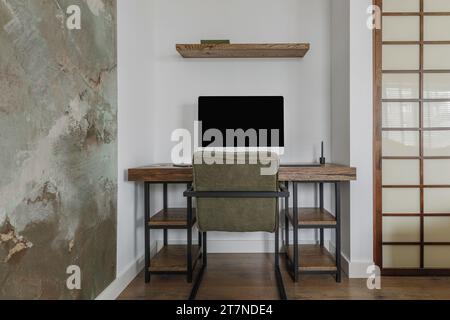 Modern Japandi interior design appartment in earth tones, natural textures with wooden solid oak furniture and sliding Japanese wood doors. Working sp Stock Photo