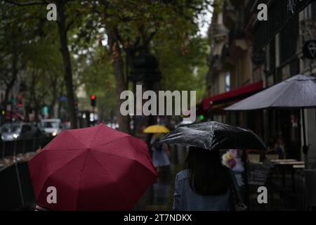 Paris, France, 27.07.2023: Pedestrians with umbrellas in rainy Paris Stock Photo