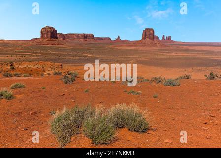 Springtime vegetation with a backdrop of Buttes and Mesas as viewed from Artist's Point in Monument Valley tribal park Stock Photo