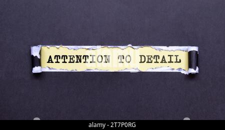 Attention To Detail. text on yellow sticker attached to notepad. gears, glasses and a white pen. Stock Photo