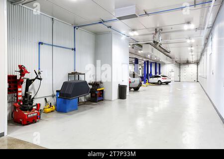 The service bay with wheel balancers and hydraulic lifts, in a clean, new, modern, car repair shop Stock Photo