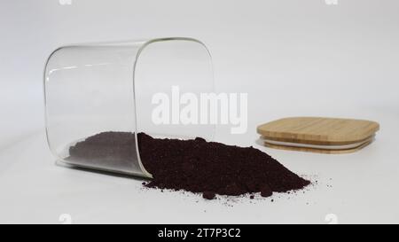 Aronia berries powder spilled from a jar. Stock Photo