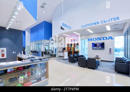 The customer waiting room with table chairs and comfortable furniture in a modern new car dealership service center. Stock Photo