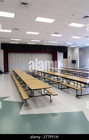 The multipurpose room in a small modern new elementary school, which functions as a gym, lunchroom, meeting room, and theater. Stock Photo