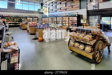 The entry way with displays of fresh produce and bread, in a modern grocery store. Stock Photo