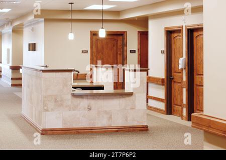 The nurses station in a rehabilitation center, located conveniently near teh patient rooms. Stock Photo