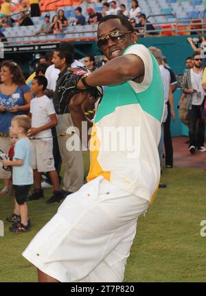 MIAMI - JULY 24:   In an effort to get the young, hip crowd into seats at Sun Life Stadium, the Florida Marlins have invited Sean “Diddy’’ Combs to throw out the first pitch and than to perform after their game on Saturday when the first place Atlanta Braves play against the Florida Marlins at the Sun Life Stadium.  Joining Diddy at the Marlins’ concert will be his new group, Dirty Money, a duo that includes ex-Danity Kane member Dawn Richard and singer Kaleena Harper. The group is also featured on Diddy’s upcoming album.  Seen here Diddy throws some warm up pitches prior to the start of the g Stock Photo