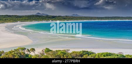 Storm clouds over green ocean beach with Mount Barren range in background at Bremer Bay, Western Australia, Australia Stock Photo