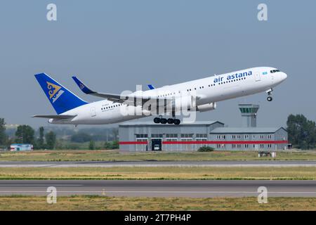 Air Astana Boeing 767 aircraft departing Almaty Airport. Plane 767 of AirAstana airline during take off. B767 airplane of Air Astana. Stock Photo