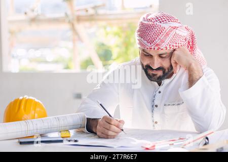 Arab construction engineer builder architect building designer working sketch design house floor plan Stock Photo