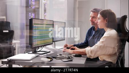 Working Analyst on Desktop Computer with Spreadsheets Stock Photo