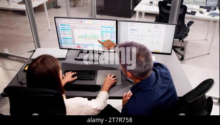 Multiple Medical Coders Working on Spreadsheets with Computers Stock Photo
