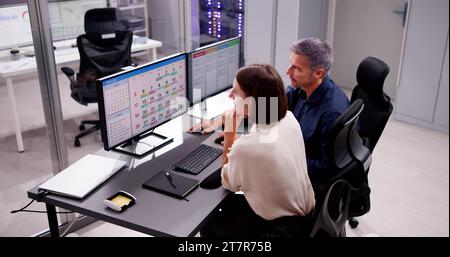 Empowered Woman Planning Schedule on Content-Focused PC Calendar Stock Photo