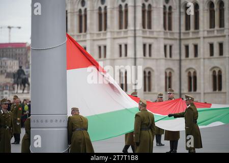 Budapest, Hungary March 15, 2023: Ceremonial raising of the Hungary flag near parliament building in Hungary national day. Stock Photo