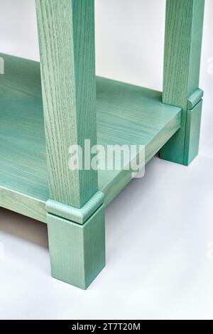 Wooden serving table with drawers and shelves of ash tree massive and green enamel paint isolated on white background closeup Stock Photo