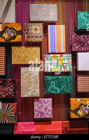 A colorful display of the wide variety of fabric, textiles, patterns sold by Jim Thompson. In the museum area above the gift shop. At the silk fabric, Stock Photo