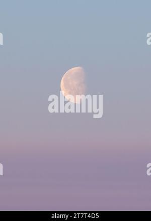 moon in a pink sky with a purple and blue sky and clouds Stock Photo