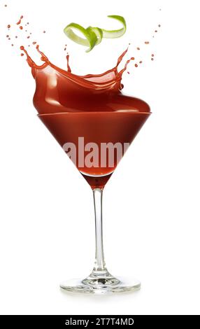 Spiral lime zest falling into a splashing red cocktail served in classic martini cup glass isolated on white background. Real studio photo shot of ele Stock Photo