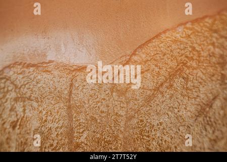 Water washing up on shore from above Stock Photo