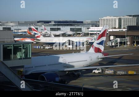 A view from Gatwick Airport's South Terminal looking towards the North Terminal including tail views of British Airways Boeing 777-200 aircraft Stock Photo