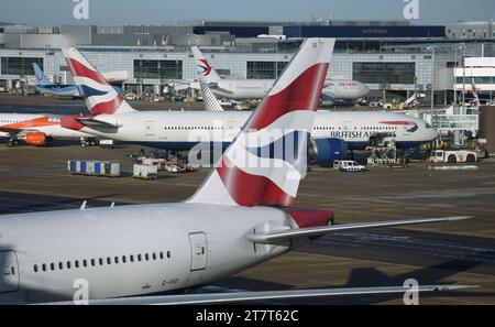 A view from Gatwick Airport's South Terminal looking towards the North Terminal including tail views of British Airways Boeing 777-200 aircraft Stock Photo