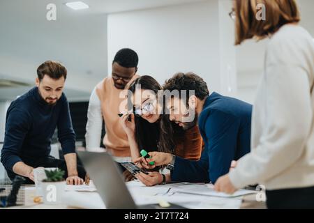 Multiracial business team analyzing reports, discussing strategies, and collaborating for company growth and successful careers. Stock Photo