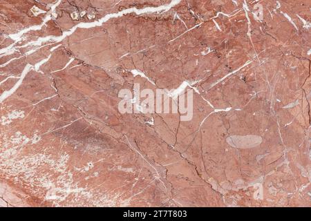 Red marble pattern with white veins. Close up photo texture. Natural stone background, front view Stock Photo