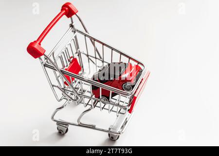 Red toy car inside small shopping cart Stock Photo