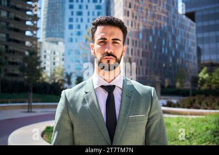 Portrait of young adult Caucasian handsome business man serious expression in formal wear outdoors. Stock Photo