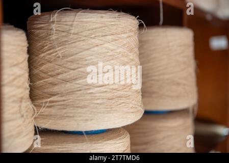 Traditional textile manufacture Weaving thread for the textile industry.extract,Rolls of industrial cotton fabric. High quality photo Stock Photo