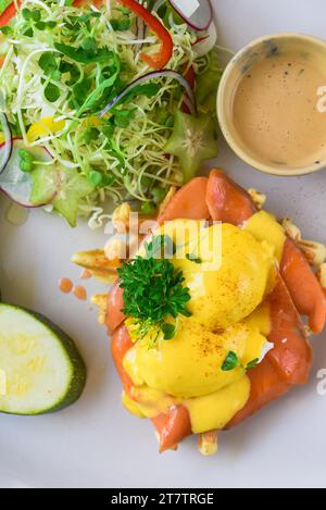 white plate with eggs bennedict waffles with smoked salmon on a white background Stock Photo