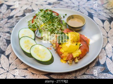white plate with eggs bennedict waffles with smoked salmon on a white background Stock Photo