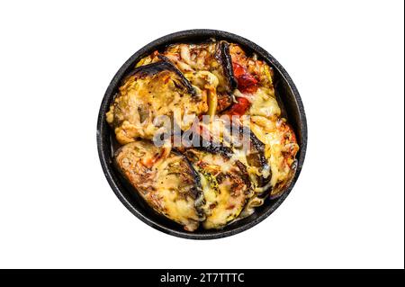 Vegetable ratatouille baked in cast-iron dish. Isolated, white background Stock Photo