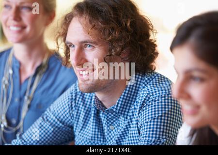 Smile, meeting and young businessman in the office planning a creative project with team of colleagues. Happy, discussion and professional male Stock Photo