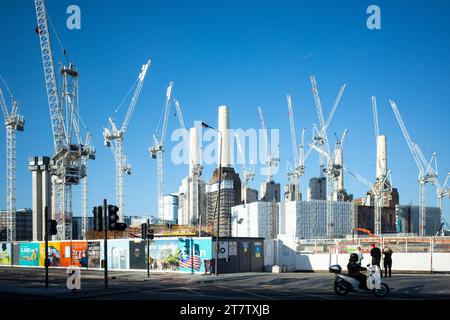 Against a bright blue sky multiple cranes rise above the construction site of the former Battersea Power Station during its redevelopment, London, UK Stock Photo