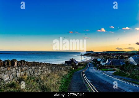 A curving road leads down to the village of Low Newton, Northumberland, England Stock Photo