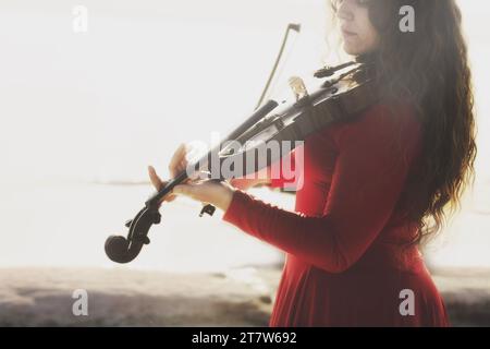 portrait of woman passionately playing the violin, abstract concept Stock Photo