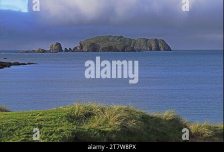 A view towards Flodaigh from Bosta Beach at high water on Bernera with approaching shower clouds on the Isle of Lewis, Outer Hebrides, Scotland. Stock Photo