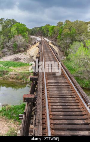 Bridge trestle over South San Gabriel River, crossed by Austin and Texas Central Railroad tracks. Hill Country Flyer tourist train ride. Stock Photo