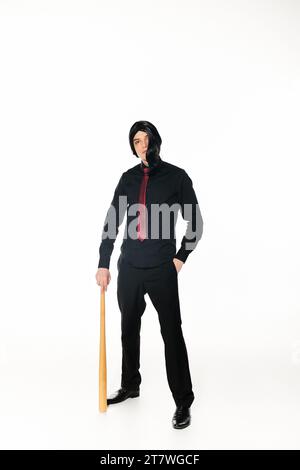 full length of anime style student in black clothes and red tie with baseball bat on white Stock Photo